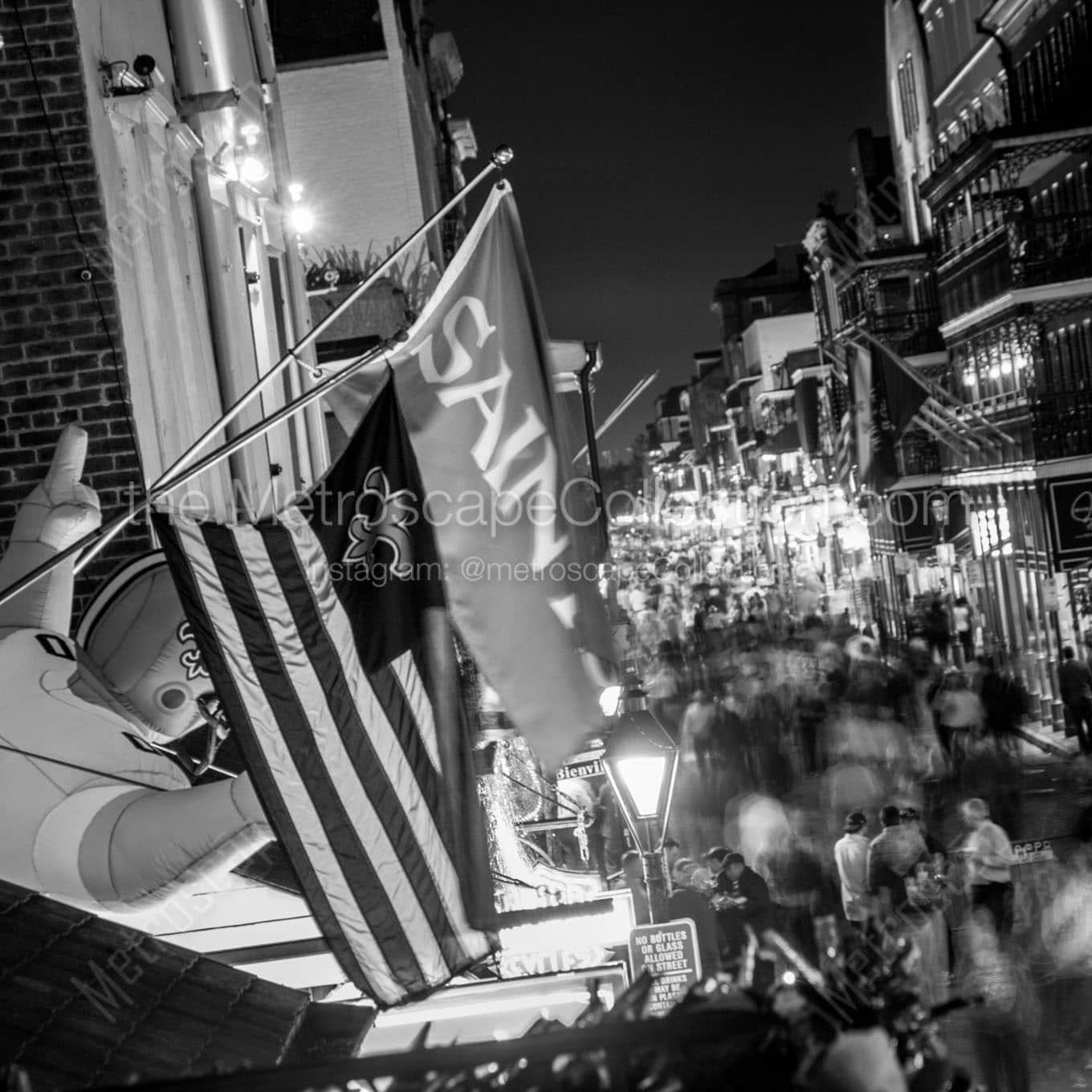 saints flag above bourbon street Black & White Wall Art